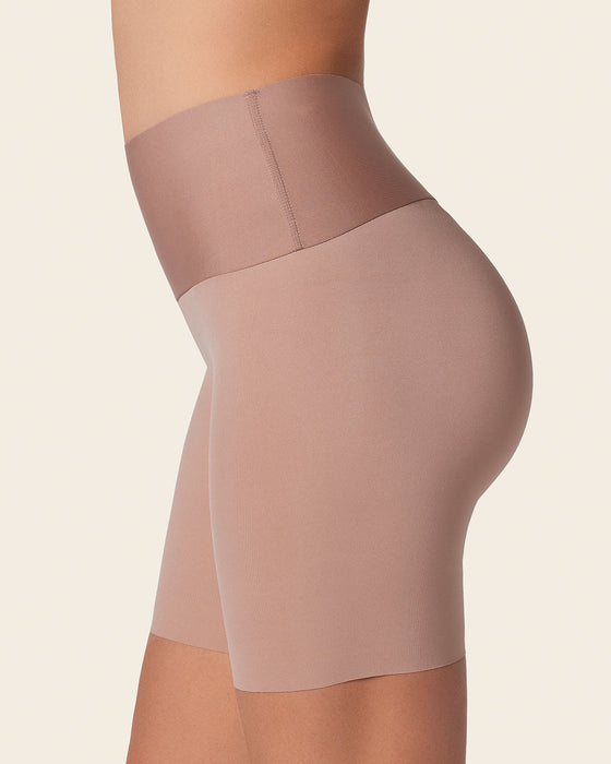 A woman modeling Leonisa shapewear in lighter colors.
